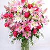 the image of awesome blossoms - pink lilies and roses bouquet in a vase