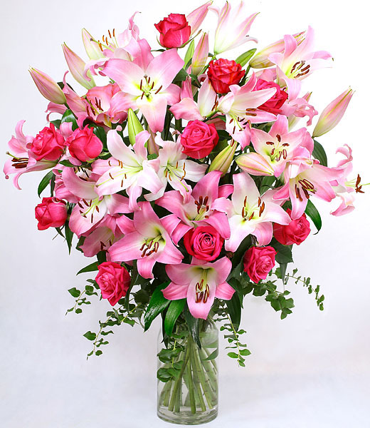 the image of awesome blossoms - pink lilies and roses bouquet in a vase