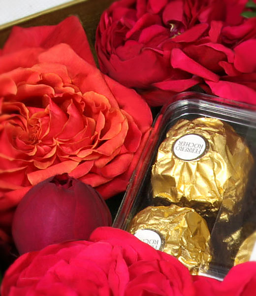 photo of red roses and chocolates in a box