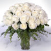 image of white long stem roses in a vase